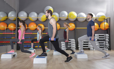 Young sporty people training in gym