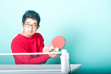 Asian man playing table tennis 