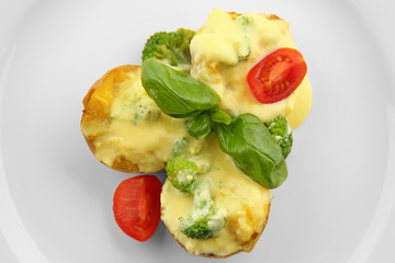 Portion of delicious baked potato with cheese sauce, closeup