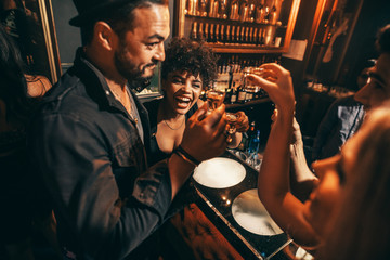 People having fun with drinks at nightclub