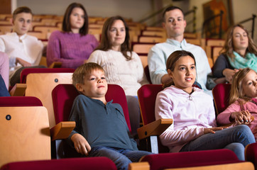 Fototapeta na wymiar Group of people watching movie attentively