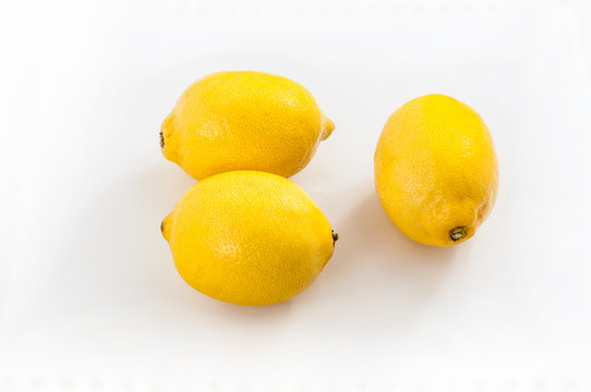 Three fresh yellow lemons