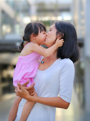 Fototapeta premium Happy loving family. mother and child girl kissing and hugging