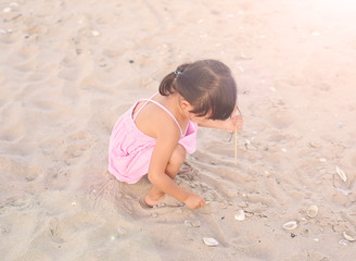 Portrait Kid girl playing sand at the beach