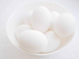 White eggs on a white background. White eggs in a white Cup.
