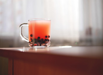 The jelly in transparent glass beaker. Drink with berries.