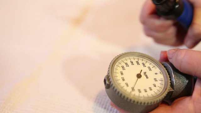 Pressure measurement by manual tonometer. Hands close up