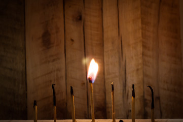 Few matches burn with wooden background