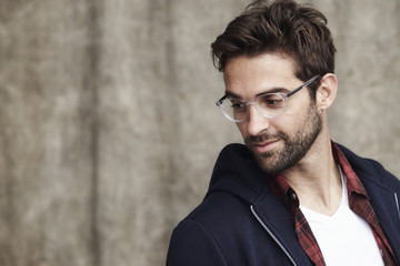 Fototapeta premium Glasses dude in hoodie in studio