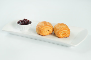 two fresh and tasty croissant over white background