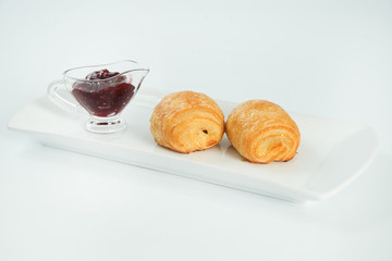 two fresh and tasty croissant over white background