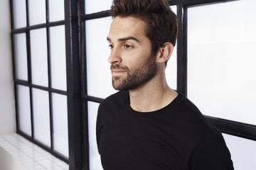 Thoughtful guy in black t-shirt, studio