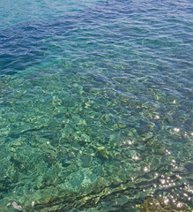 Fototapeta na wymiar Rustic pier clear green water