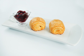 two fresh and tasty croissant over white background