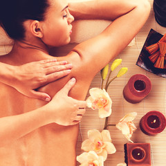 Adult woman in spa salon having body massage.