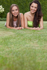 Portrait of attractive young female friends relaxing in park