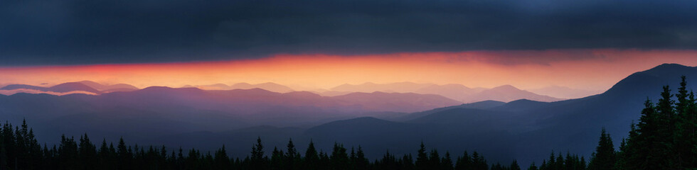 Naklejka na ściany i meble Majestic sunset in the mountains landscape with sunny beams. Dra