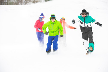 Full length of young friends having fun in snow