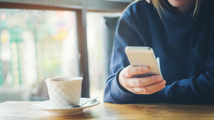 woman using on mobile phone during rest in coffee shop