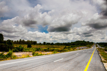 Landscape with highway road and raining clouds in Thailand
