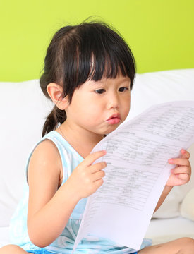 Little girl holding sheet of paper