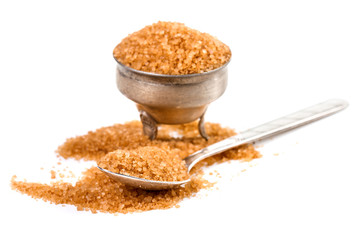 close up of brown sugar on white background