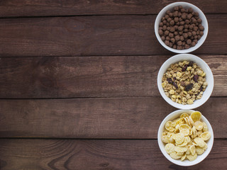 Bowls of various cereals  from top view . Wooden baclground