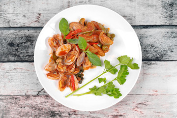 Soft-boiled blood cockles shell  served with spicy sauce.