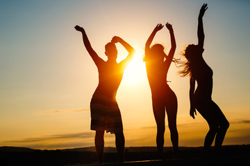 Group of happy young people enjoying summer sunset