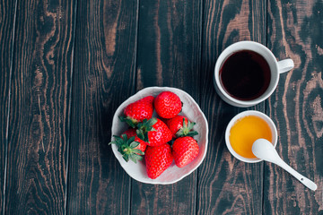 Cup of coffee and strawberries top view