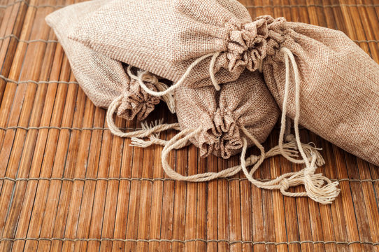 Four burlap sack or bag on bamboo table 