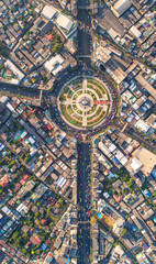 Road roundabout with car lots Wongwian Yai in Bangkok,Thailand. street large beautiful downtown at evening light.  Aerial view , Top view ,cityscape ,Rush hour traffic jam
