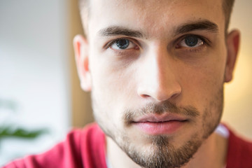 Close-up portrait of confident man in cafe