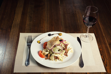 Warm salad with veal, pepper cabbage, tomatoes and onions. Serving dishes in a restaurant, European cuisine, European restaurant, pub