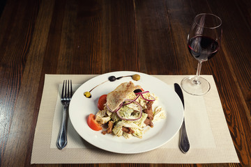 Warm salad with veal, pepper cabbage, tomatoes and onions. Serving dishes in a restaurant, European cuisine, European restaurant, pub