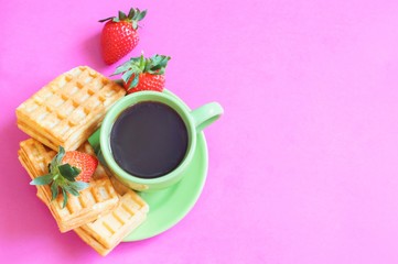 Morning cup of coffee and dessert/ Flat lay photography cup of coffee and waffles with strawberries on a pink background