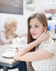 Thoughtful young woman having coffee in cafe