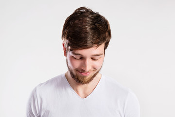 Handsome hipster fitness man in white t-shirt, studio shot.