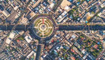 Road roundabout with car lots Wongwian Yai in Bangkok,Thailand. street large beautiful downtown at evening light.  Aerial view , Top view ,cityscape ,Rush hour traffic jam