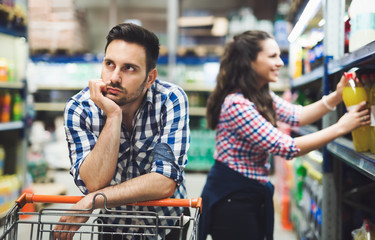 Husband bored while shopaholic woman enjoys