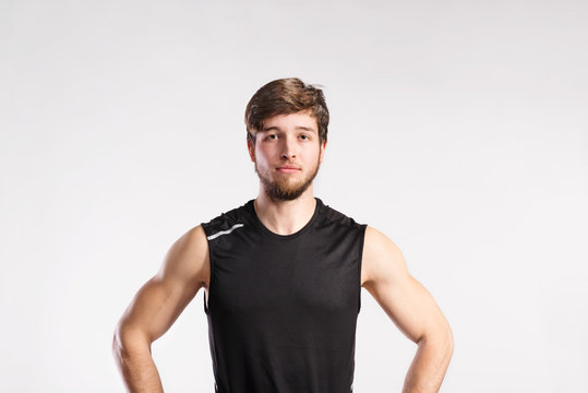 Handsome Fitness Man In Black Sleeveless Shirt, Studio Shot.