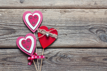 Background with decorative wooden hearts on old boards. Place for text.