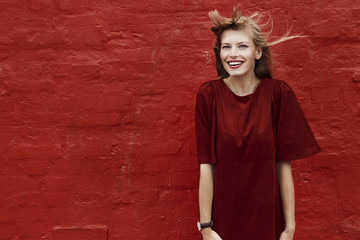 Portrait of beautiful woman in red dress, smiling