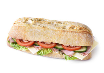Delicious ciabatta sandwich with ham, tomatoes, fresh salad and cucumber slices. Isolated on white background.