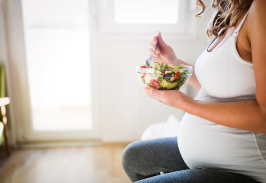 Beautiful pregnant woman eating healthy food