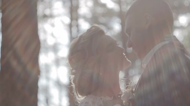 Bride and groom kissing in the forest close-up