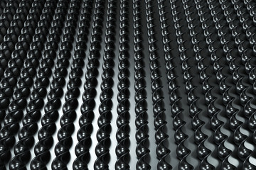 Black plastic spiral sticks on black background