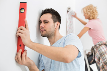 Couple working together in new house