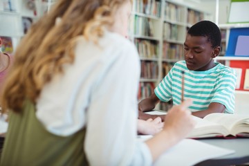 Attentive classmates studying in library