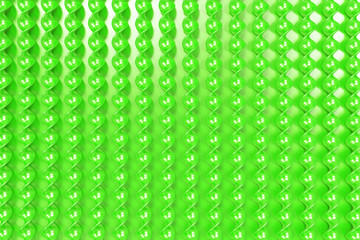 Green plastic spiral sticks on green background
